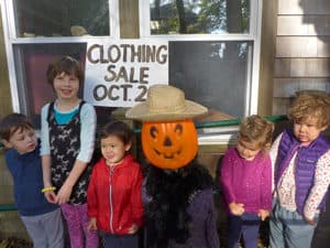 Picture of children in front of Clothing Sale Sign. October 16th 
9:00 AM - 3:00 PM